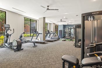 Cardio and strength training fitness center featuring echelon smart connect exercise bikes, hiit hub with trx suspension trainer, free weights